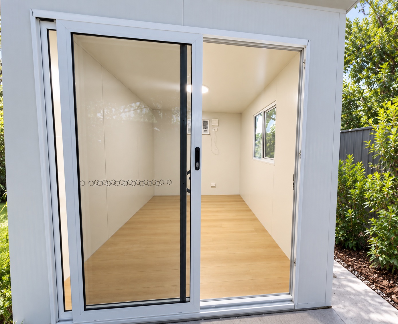Clean Easy Portable Hire room interior with timber-look floor, window and air conditioner